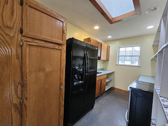 kitchen featuring separate washer and dryer, black refrigerator with ice dispenser, and a skylight