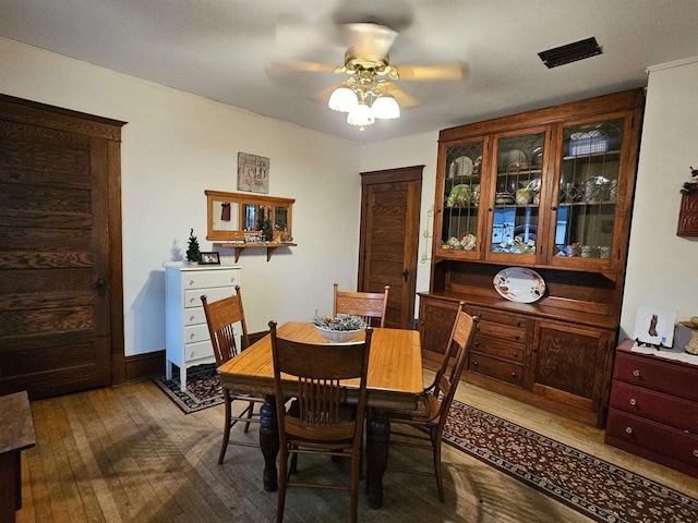 dining space featuring ceiling fan and wood-type flooring