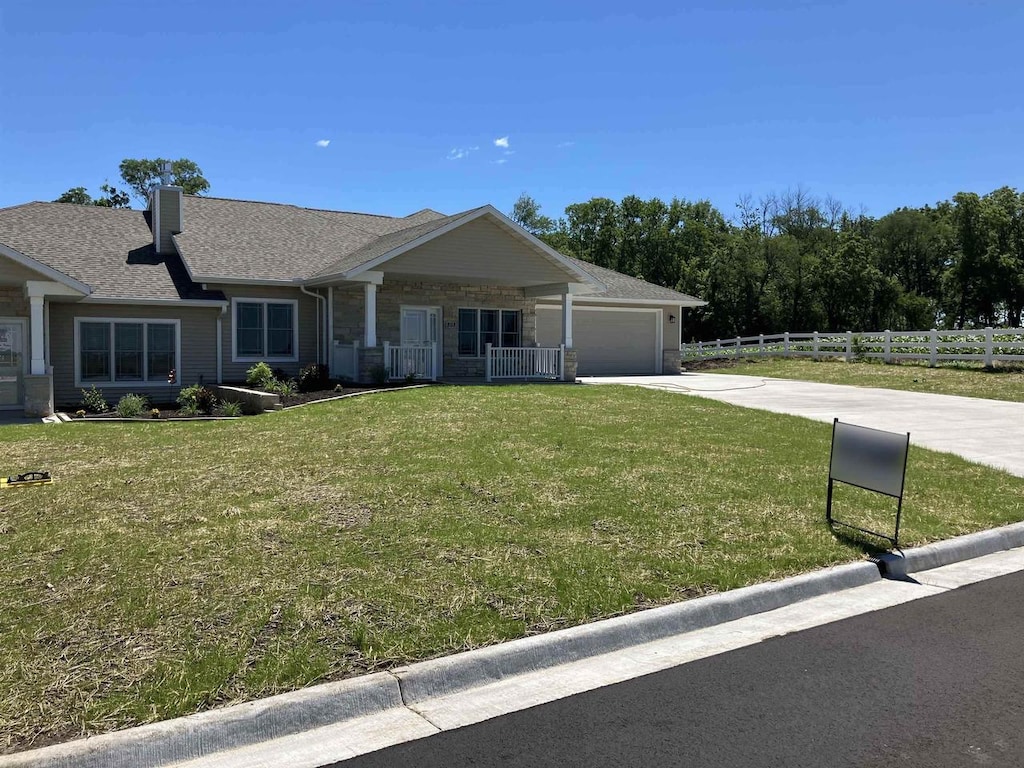 ranch-style house with a front yard and a garage