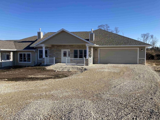 ranch-style home with covered porch and a garage