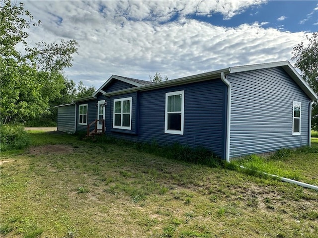 view of side of property with a yard