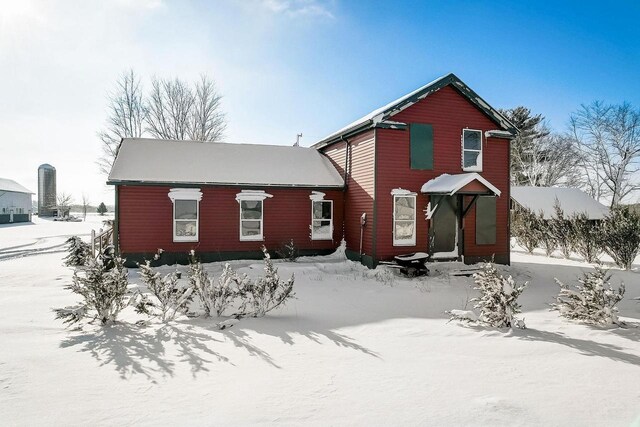 view of snow covered back of property