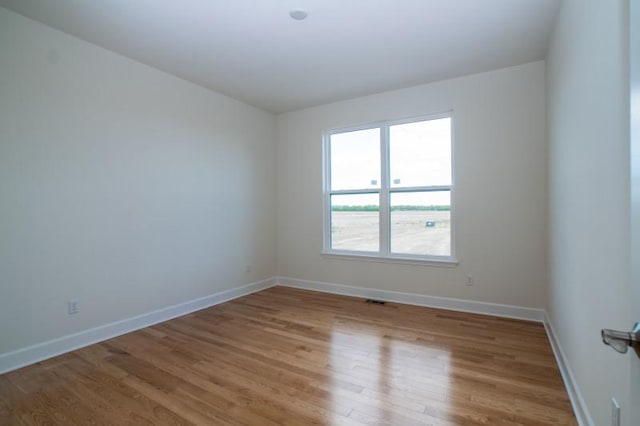 unfurnished room with wood-type flooring