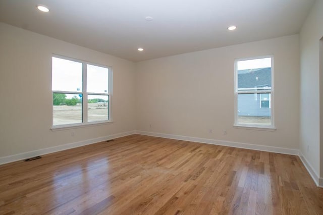 unfurnished room with light wood-type flooring