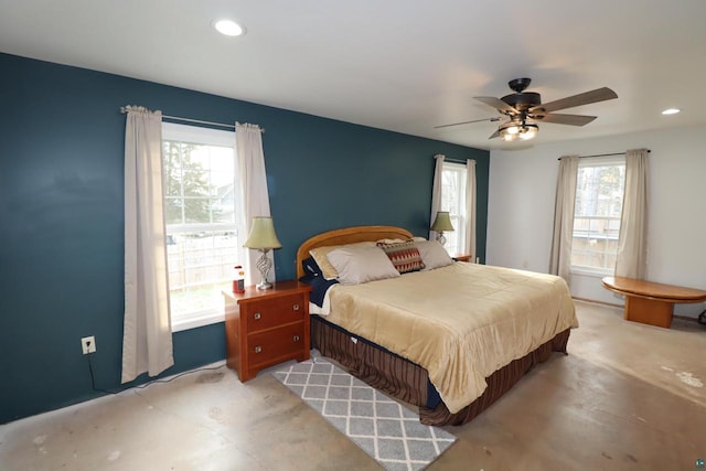 bedroom featuring multiple windows and ceiling fan