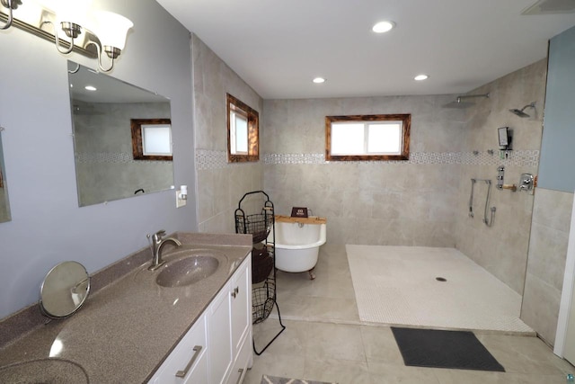 bathroom with tile walls, vanity, tile floors, and shower with separate bathtub