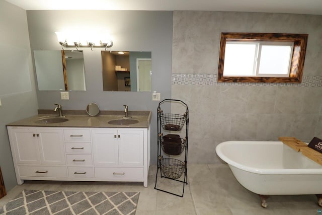 bathroom with tile floors, tile walls, double vanity, and a tub