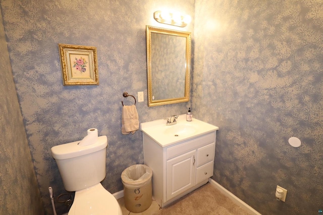 bathroom featuring toilet and vanity