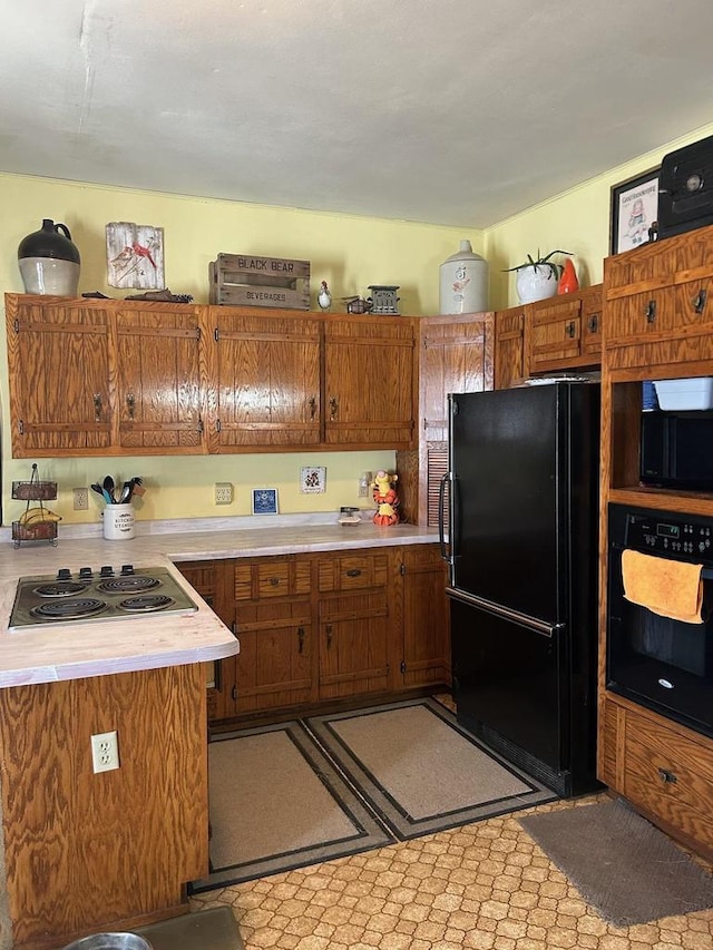 S1205 County Road Y, Wonewoc, WI 53968 - kitchen featuring light tile flooring and black appliances