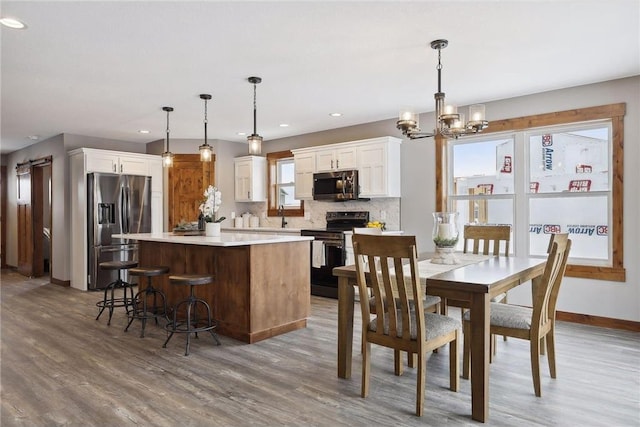 dining space with an inviting chandelier, dark hardwood / wood-style floors, and sink