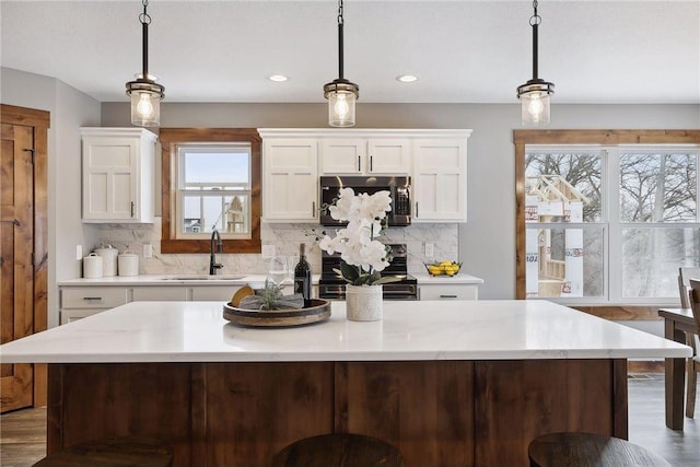 kitchen featuring pendant lighting, sink, and stove