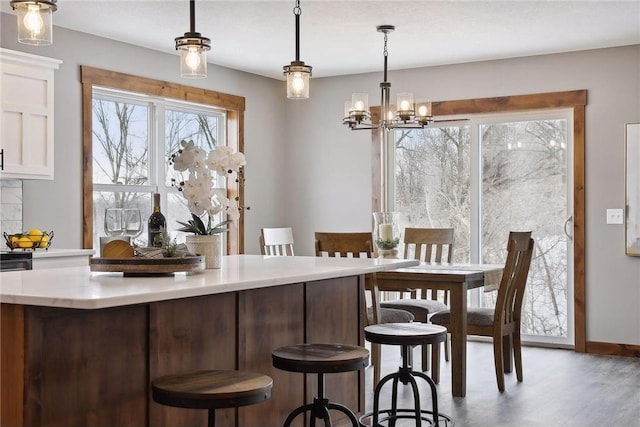 bar featuring hanging light fixtures, white cabinetry, and dark wood-type flooring