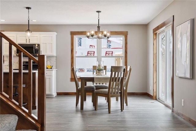 dining space featuring a notable chandelier and hardwood / wood-style flooring