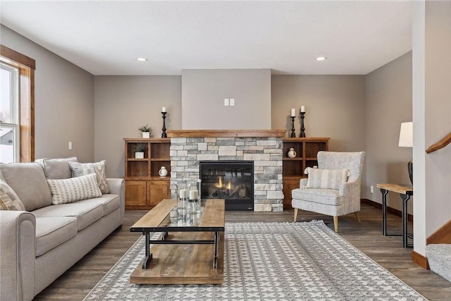 living room featuring hardwood / wood-style flooring and a stone fireplace