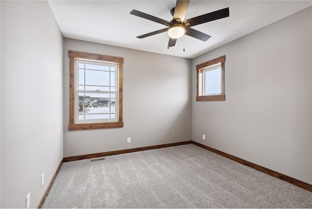 spare room with ceiling fan and carpet flooring