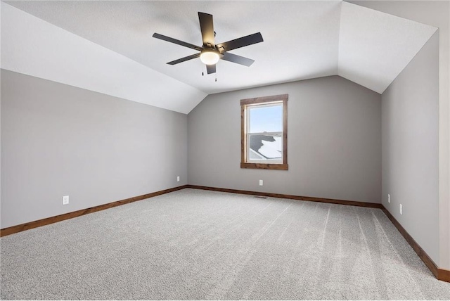 additional living space featuring carpet floors, vaulted ceiling, and ceiling fan