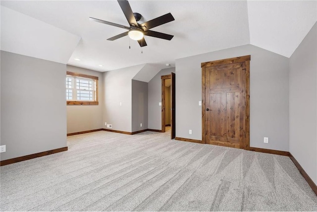 bonus room with ceiling fan, lofted ceiling, and light carpet