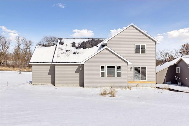 view of snow covered back of property