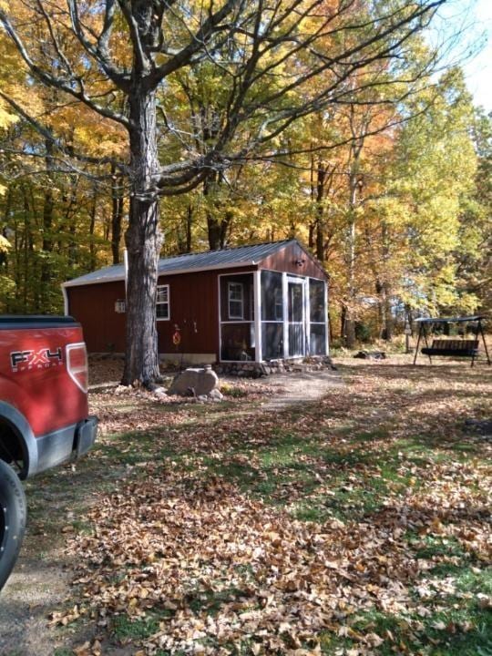 view of front of home featuring a sunroom