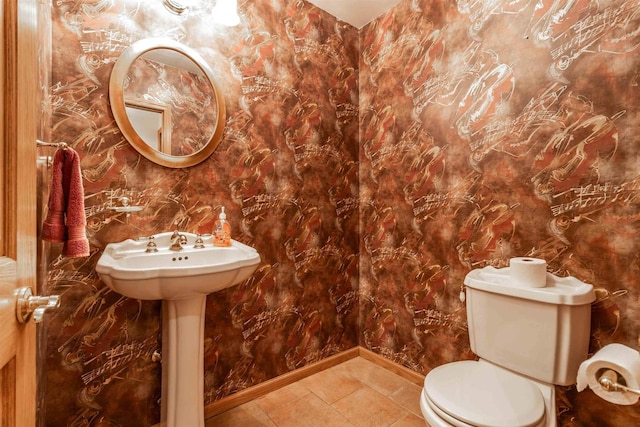 bathroom with toilet and tile floors