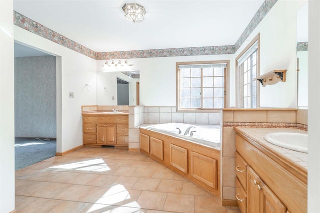 bathroom with tile flooring, tiled bath, and double vanity