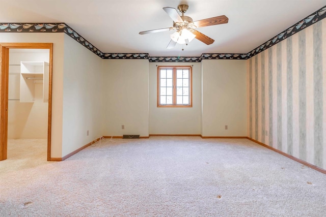 empty room with light carpet and ceiling fan