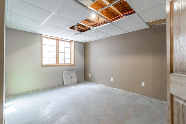 unfurnished room with a drop ceiling