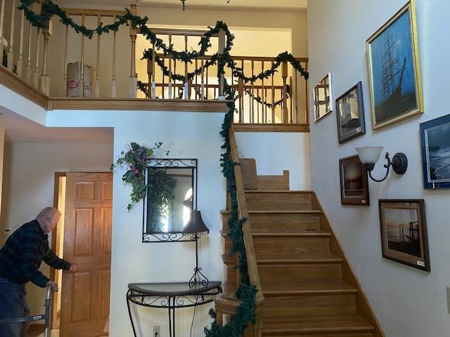 stairway with a notable chandelier