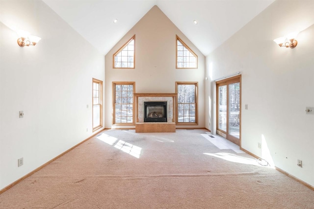 unfurnished living room featuring light colored carpet and high vaulted ceiling