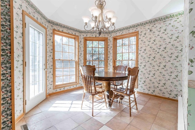 dining space featuring a notable chandelier, a healthy amount of sunlight, and light tile floors