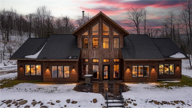 view of snow covered back of property