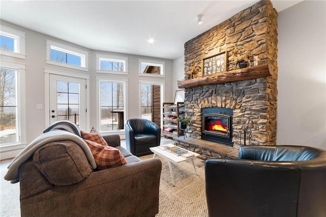 living room featuring carpet floors and a stone fireplace