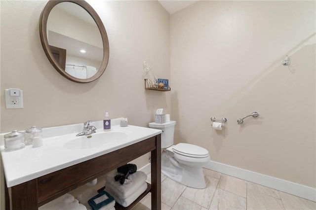 bathroom with toilet, tile floors, and sink