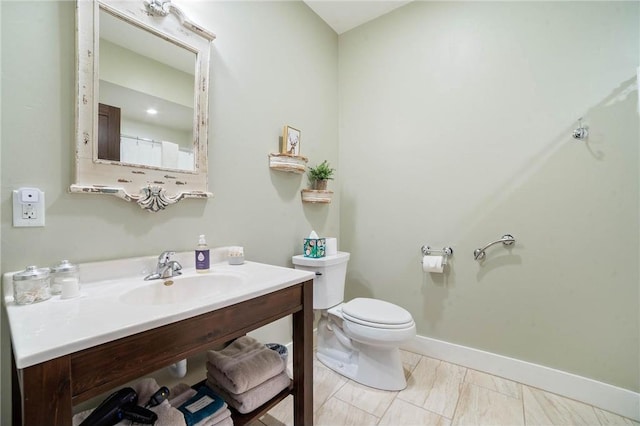 bathroom with tile flooring, toilet, and vanity