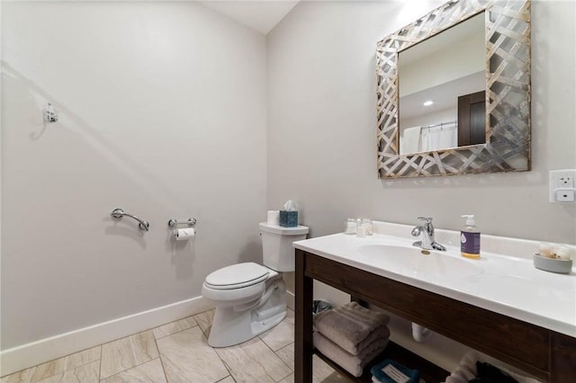 bathroom with toilet, sink, and tile flooring