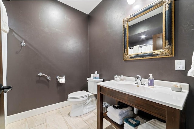 bathroom with toilet, tile flooring, and sink