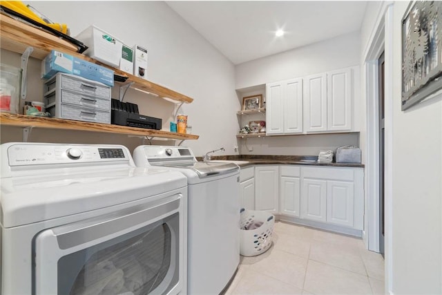 laundry area featuring sink, cabinets, washer and clothes dryer, and light tile floors