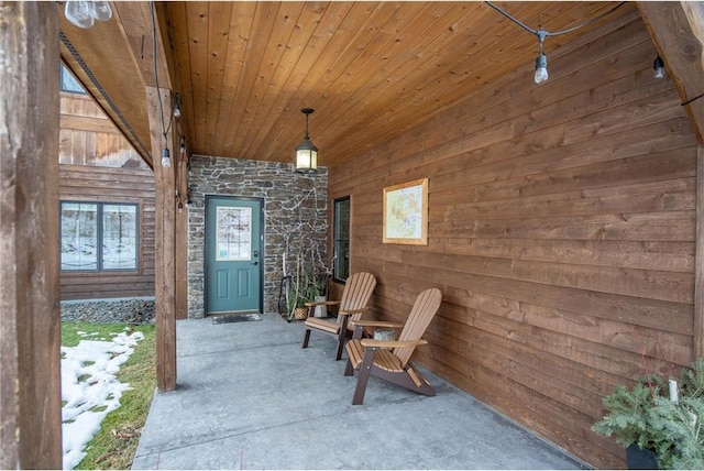 view of exterior entry with a patio area