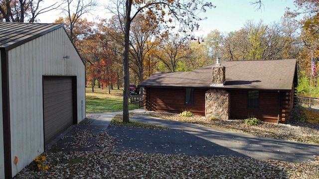 view of property exterior featuring a garage and an outdoor structure