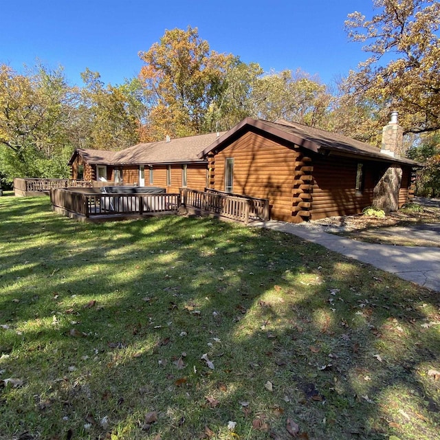 view of property exterior featuring a deck and a lawn