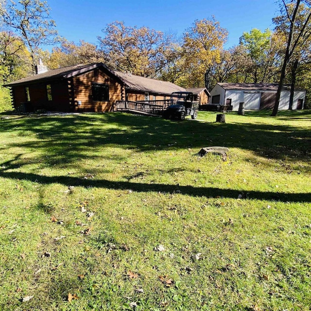 view of yard with a deck and an outdoor structure