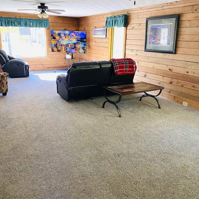 living room with wooden walls, carpet, and ceiling fan