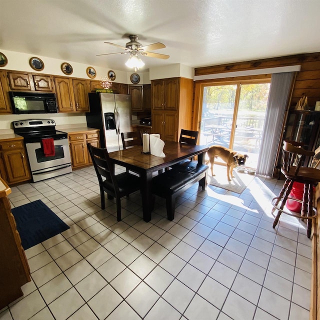 tiled dining area featuring ceiling fan