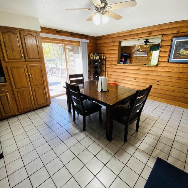 dining area featuring log walls, ceiling fan, and light tile flooring