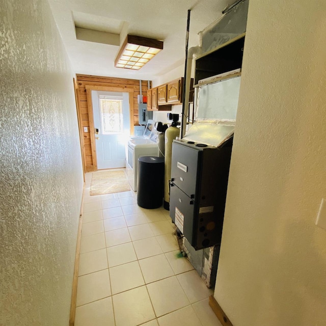 laundry area with cabinets, electric dryer hookup, separate washer and dryer, and light tile floors