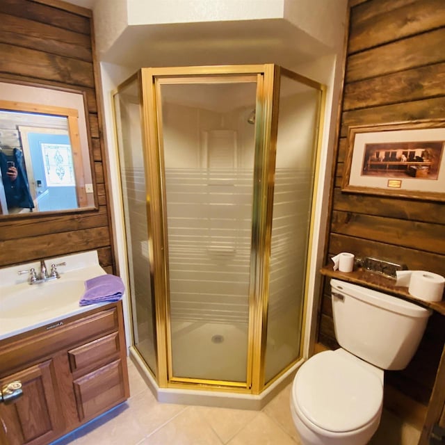 bathroom featuring a shower with shower door, vanity, toilet, and tile flooring