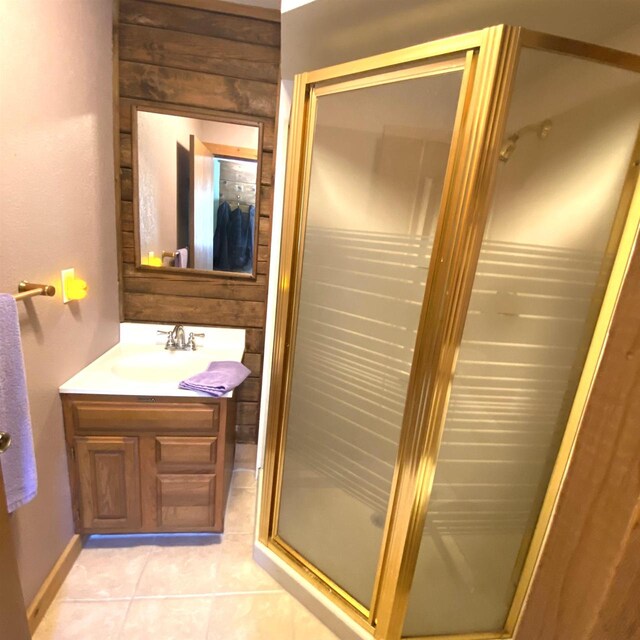 bathroom featuring tile flooring, vanity, and a shower with door