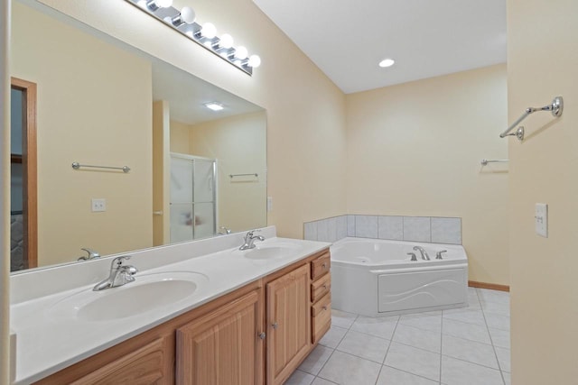 bathroom featuring shower with separate bathtub, dual sinks, tile flooring, and vanity with extensive cabinet space