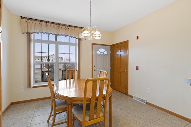 tiled dining area with an inviting chandelier