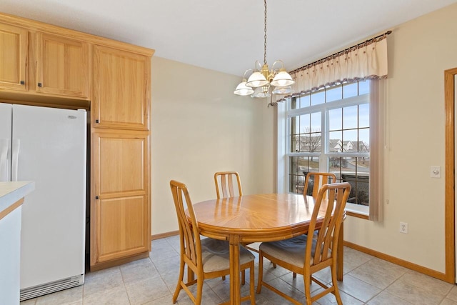 tiled dining space with a notable chandelier